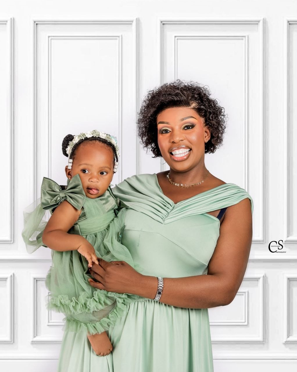 Mother and daughter wearing matching green dresses