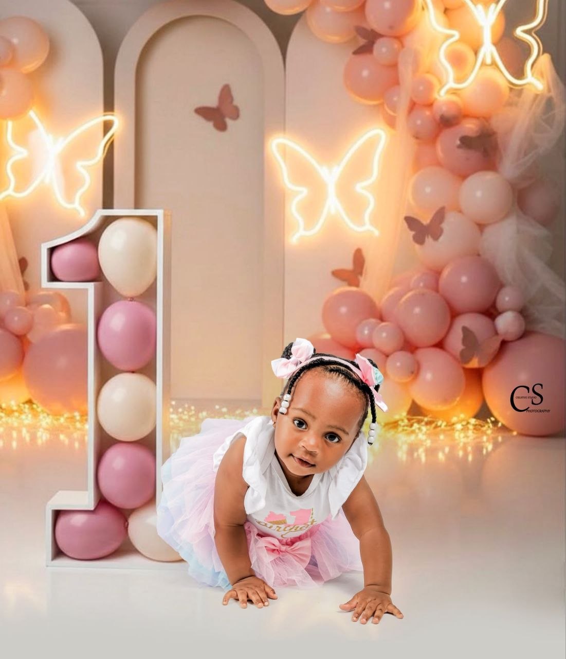Baby girl crawling at a glowing butterfly set