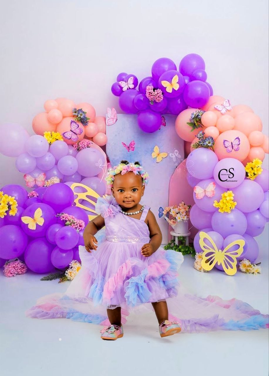 Baby girl at a colourful purple butterfly set