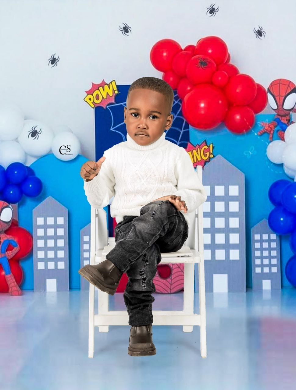 Young boy posing at a Spider-Man birthday set